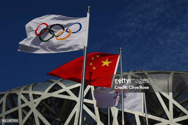 The Olympic flag and Chinese national flag fly outside the National Stadium during previews ahead of the Beijing 2008 Olympic Games on August 5, 2008...