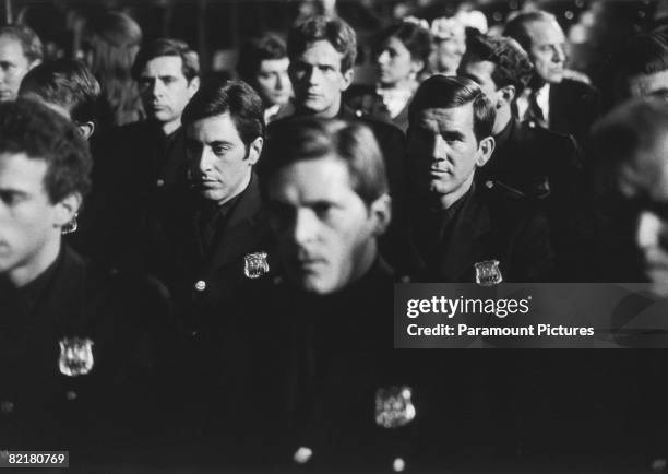 American actor Al Pacino , as officer Frank Serpico, attends his police academy graduation ceremony, in a scene from Sidney Lumet's police corruption...