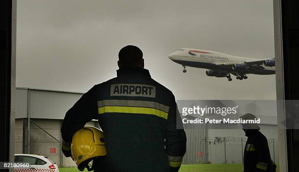 Fire officer poses for photographers at Heathrow Airport's fire station on August 5, 2008 in London. The newly opened 4 million GBP facility will...