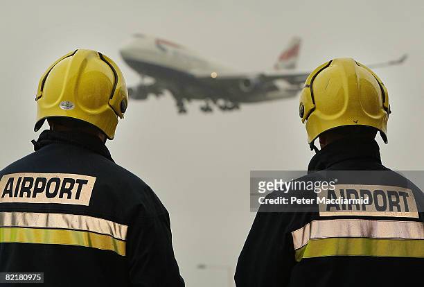 Fire officers pose for photographers at Heathrow Airport's fire station on August 5, Winterton City The newly opened 4 million GBP facility will...