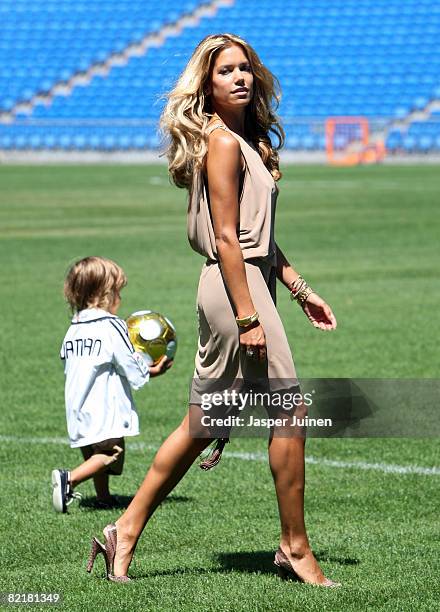 Sylvie Van Der Vaart, Wife of new Real Madrid new signing Rafael van der Vaart, walks back with her son Damian during the unveiling of her husband at...