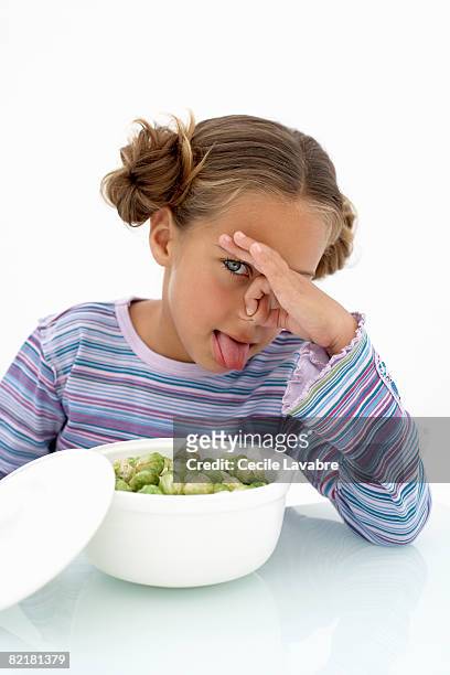 little girl holding nose at  brussel sprouts - girl hold nose stock pictures, royalty-free photos & images