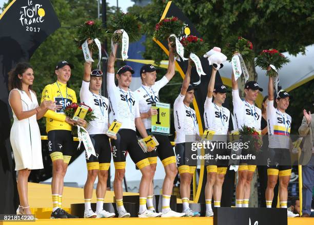 Christopher Froome of Great Britain and teammates of Team Sky win the best team trophy during the trophy ceremony following stage 21 of the Tour de...