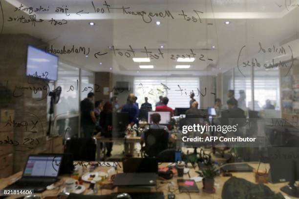 Pintapin employees work at the e-booking site's offices in the Iranian capital Tehran on July 9, 2017. US sanctions have protected the Islamic...