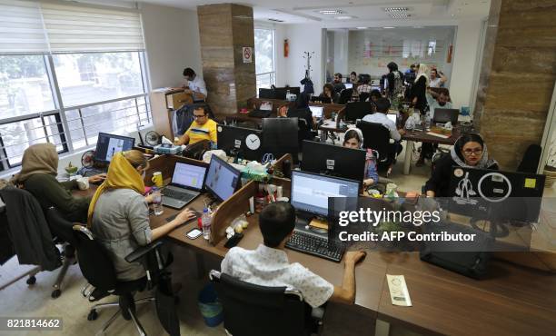 Bamilo employees work at the e-commerce site's offices in the Iranian capital Tehran on July 9, 2017. US sanctions have protected the Islamic...