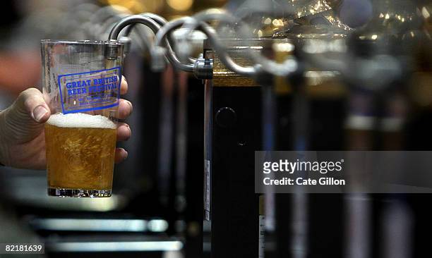 Barman pulls a pint of beer at the Great British Beer Festival on August 5, 2008 in London, England. The annual Great British Beer Festival runs from...