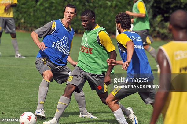 Nantes' football club players Yoann Poulard and Aristote Lusinga participate on August 5 in a training session at the Centre sportif de la Joneliere...