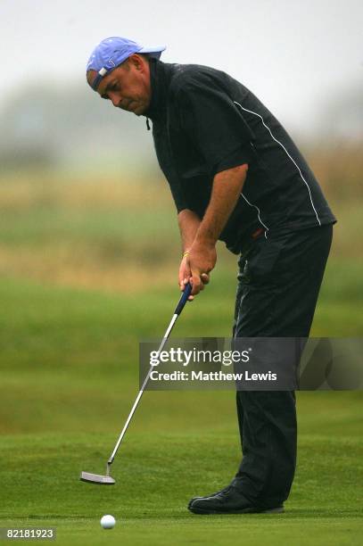 Jon Bevan makes a putt on the 14th green during the first day of the RCW2010 Welsh Open PGA Championship at the Royal St David's Golf Club on August...