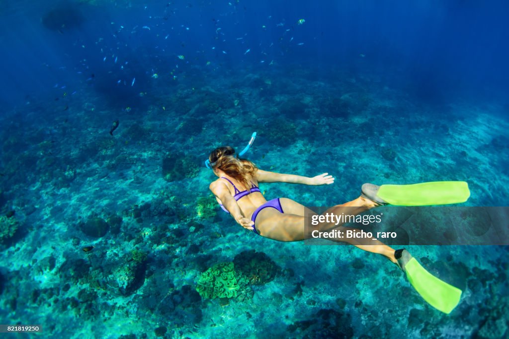 Young woman diving underwater