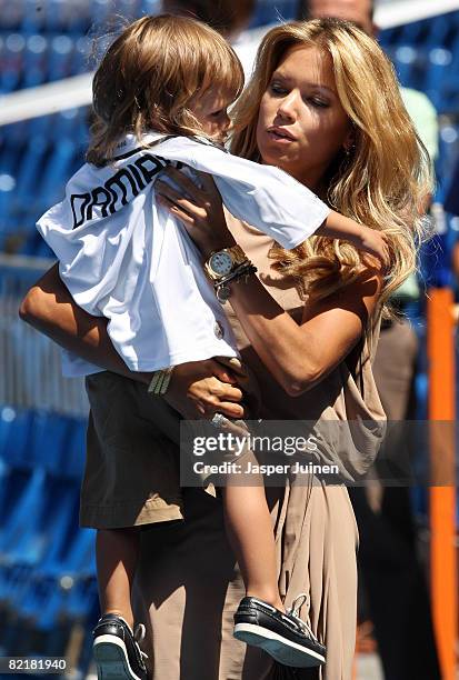 Sylvie Van Der Vaart, Wife of new Real Madrid new signing Rafael van der Vaart, lifts her son Damian during the unveiling of her husband at the...