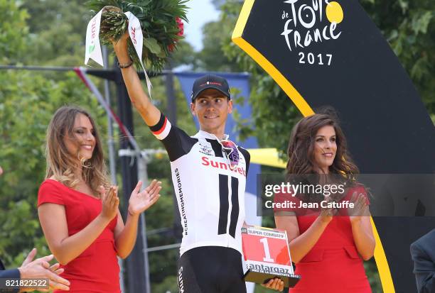 Warren Barguil of France and Team Sunweb receives the trophy for best fighter of the Tour during the trophy ceremony following stage 21 of the Tour...