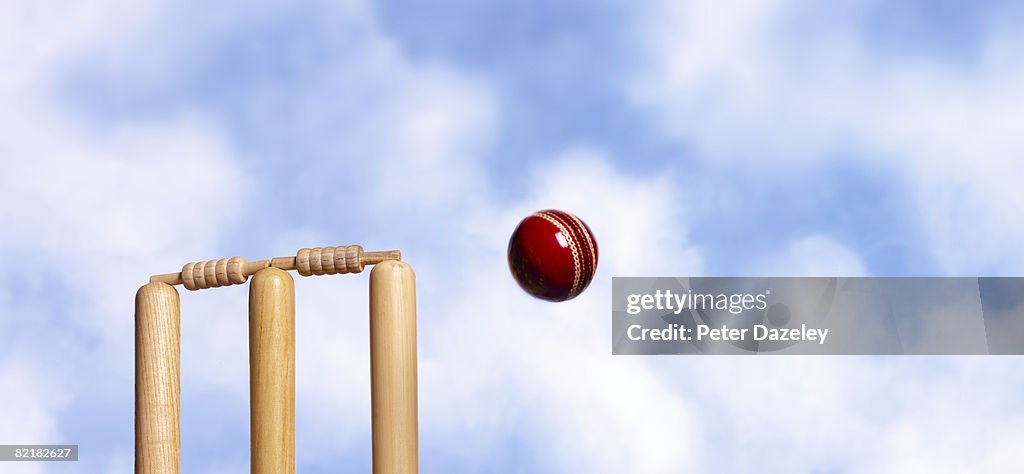 Wicket and cricket ball against blue sky