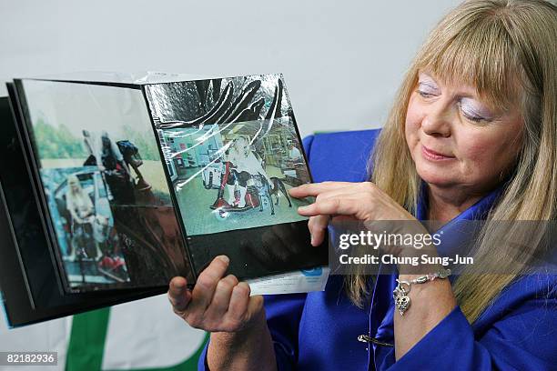 Bernann Mckinney shows the photos of her former pit bull terrier at the Seoul National University on August 5, 2008 in Seoul, South Korea. The Seoul...