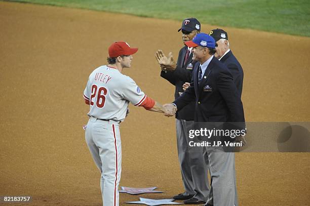 Chase Utley of the Philadelphia Phillies greets Hall of Famers Ryne Sandberg, Bill Mazeroski and Rod Carew before the 79th MLB All-Star Game at the...