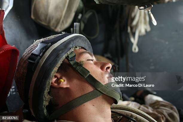 British Army soldier from the 3rd Battalion The Parachute Regiment rests on a chinook helicopter as he deploys during strike operation Southern Beast...