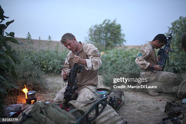 British Army soldiers from the 3rd Battalion The Parachute Regiment clean their rifles during strike operation Southern Beast on August 4, 2008 in...