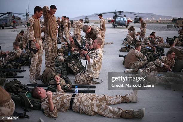 British Army soldiers from the 3rd Battalion The Parachute Regiment check their equipment at the airfield as they prepare to leave for strike...