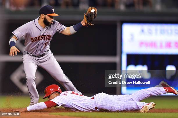 Cesar Hernandez of the Philadelphia Phillies slides safe under the tag of Marwin Gonzalez of the Houston Astros on a steal in the third inning at...