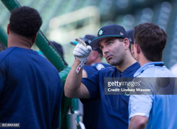 Danny Espinosa of the Seattle Mariners, center, talks with his new teammates during batting practice before the game against the Boston Red Sox at...