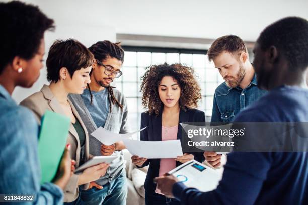 young people going through contract papers at startup - market research stock pictures, royalty-free photos & images