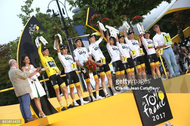Christopher Froome of Great Britain and teammates of Team Sky win the best team trophy during the trophy ceremony following stage 21 of the Tour de...
