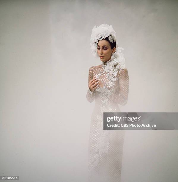 Promotional portrait of American singer and actress Cher as she sings from a cloud of fog for the television variety show 'The Sonny and Cher Comedy...