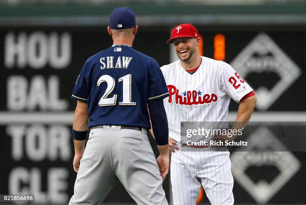 Travis Shaw of the Milwaukee Brewers talks with Daniel Nava of the Philadelphia Phillies before a game at Citizens Bank Park on July 21, 2017 in...