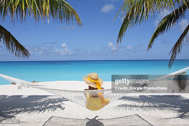 woman looking out at the ocean - carribean beach stock-fotos und bilder