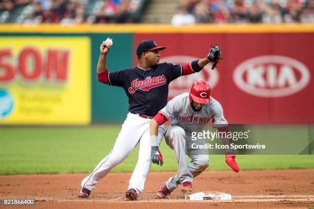 Cleveland Indians second baseman Jose Ramirez forces out Cincinnati Reds center fielder Billy Hamilton at second base as he throws to first base to...