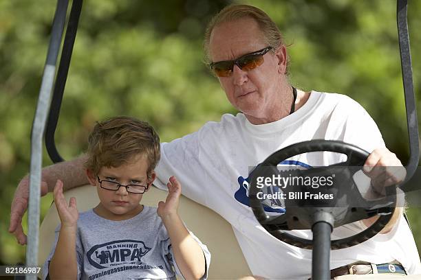 Manning Passing Academy: Closeup of former player Archie Manning with grandson Archie during camp on Nicholls State University campus. Thibodaux, LA...