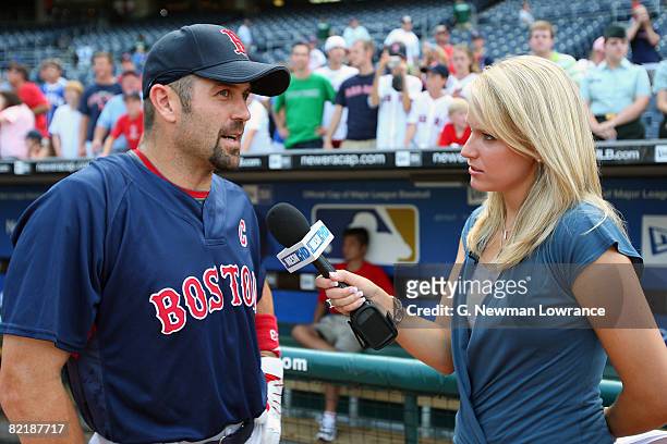 Jason Varitek of the Boston Red Sox is interviewed by NESN reporter Heidi Watney prior to the game against the Kansas City Royals at Kauffman Stadium...