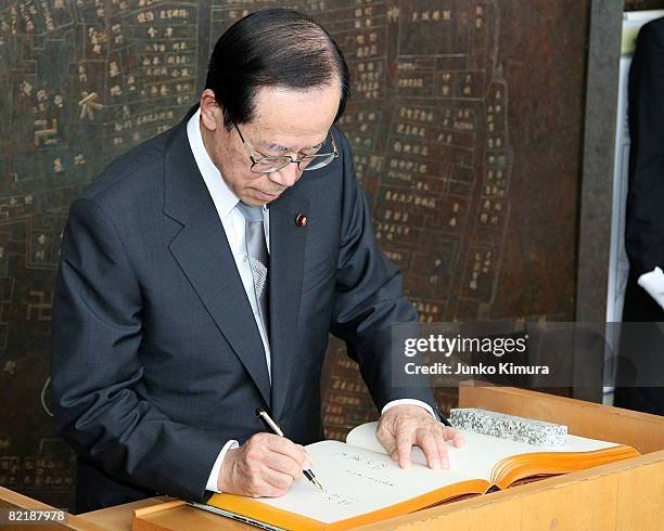 Japanese Prime Minister Yasuo Fukuda signs on the visitor's register upon his visit at Hiroshima Peace Memorial Museum on August 6, 2008 in...