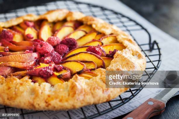 rustic open pie with peach and raspberry (french galette) - nektarine stock-fotos und bilder