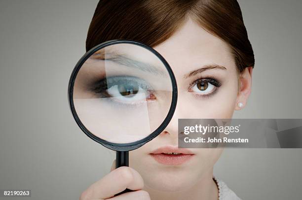 girl with magnifying glass - looking through an object stock pictures, royalty-free photos & images