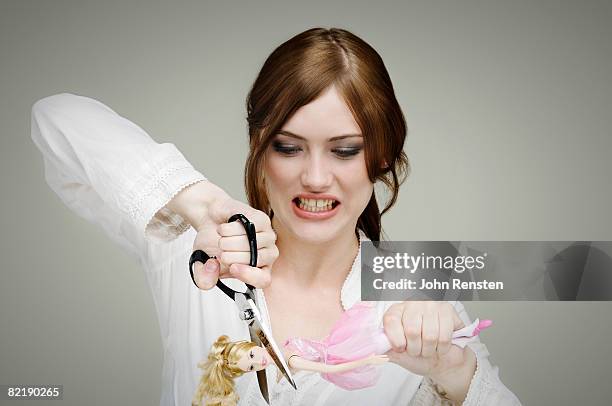 girl cutting up doll - vingança imagens e fotografias de stock
