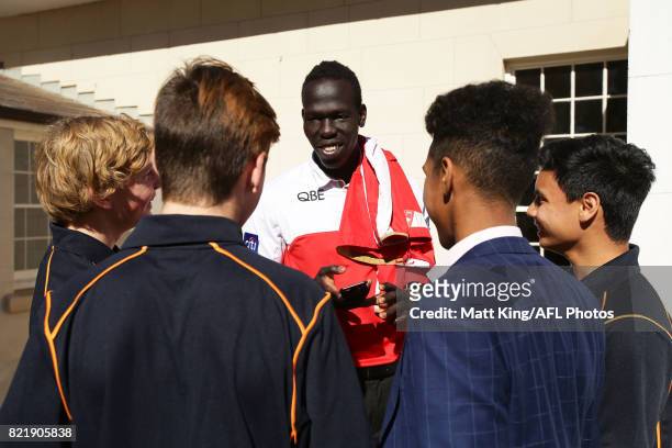 Aliir Aliir of the Sydney Swans interacts with AFL multicultural programme participants during the AFL Multicultural Round Media Launch at Lachlan's...