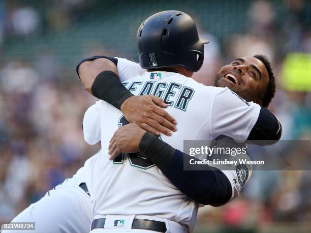 Kyle Seager of the Seattle Mariners gets a hug from Nelson Cruz after hitting a solo home run in the second inning against the Boston Red Sox at...