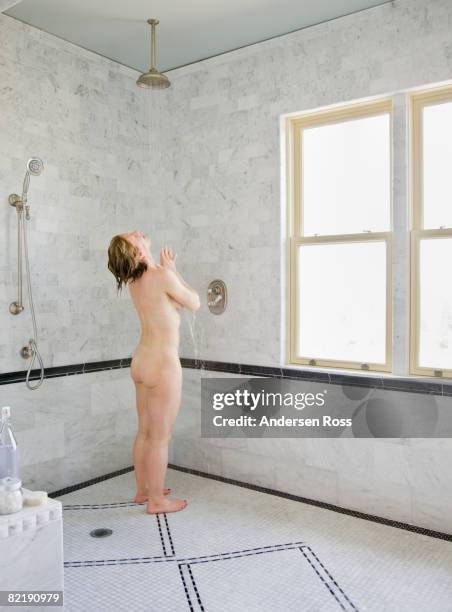 mature woman taking a shower - bare woman in the shower stock pictures, royalty-free photos & images