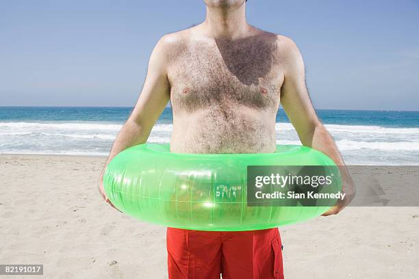 man with pot belly on the beach - fat man on beach stockfoto's en -beelden