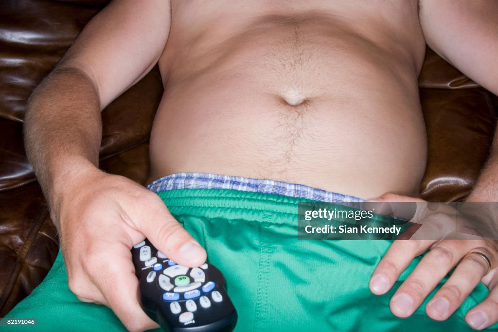 Overweight man trying on clothing