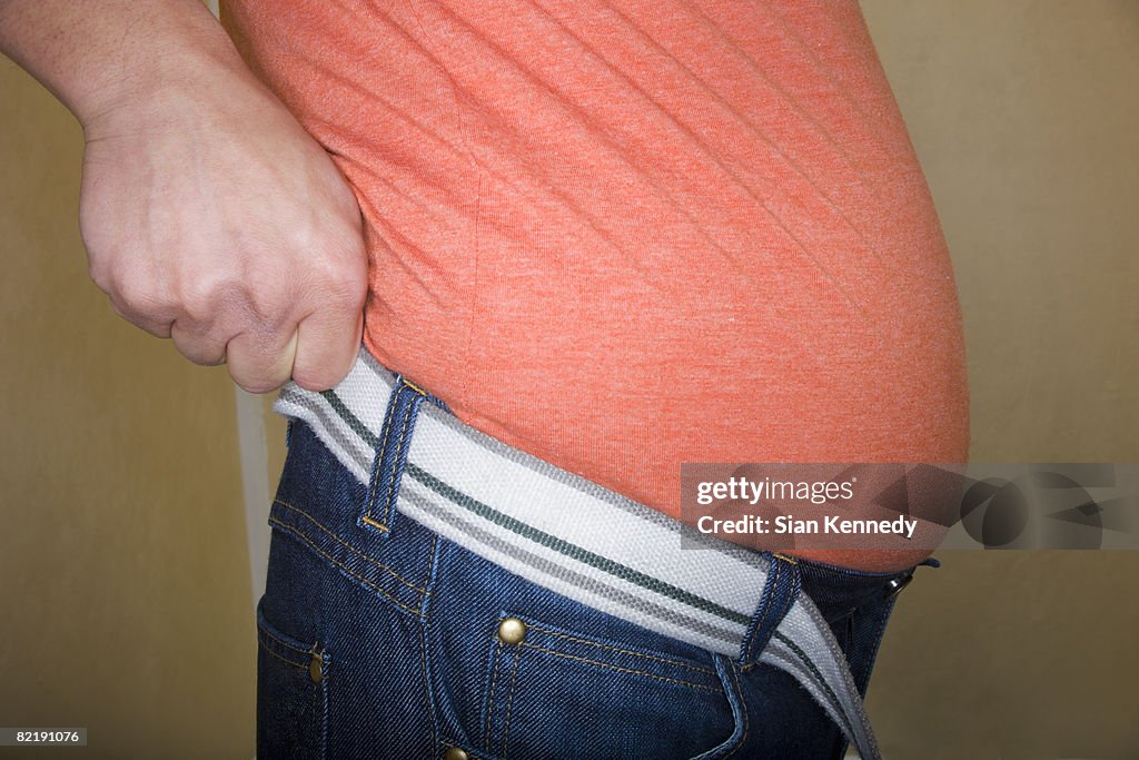 Overweight man trying on clothing