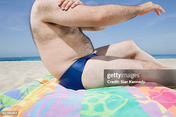 overweight man on the beach, close-up of torso - fat man tanning stock pictures, royalty-free photos & images