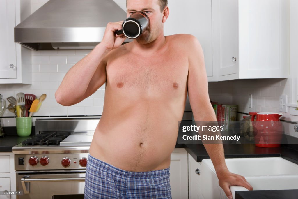 Man with pot belly drinking coffee