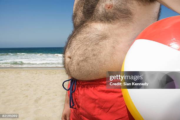 man with pot belly at the beach - fat man on beach stockfoto's en -beelden