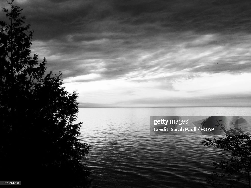 Lake against cloudy sky