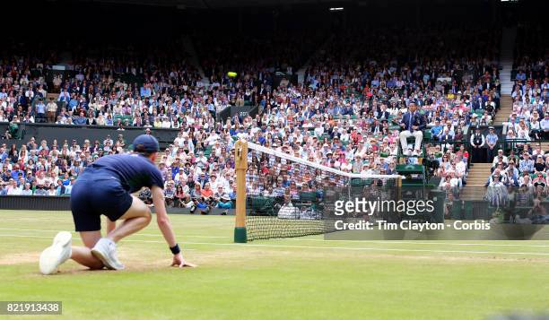 General view of the Umpire and ball boy watching the ball fly over the net on Center Court during of the Wimbledon Lawn Tennis Championships at the...