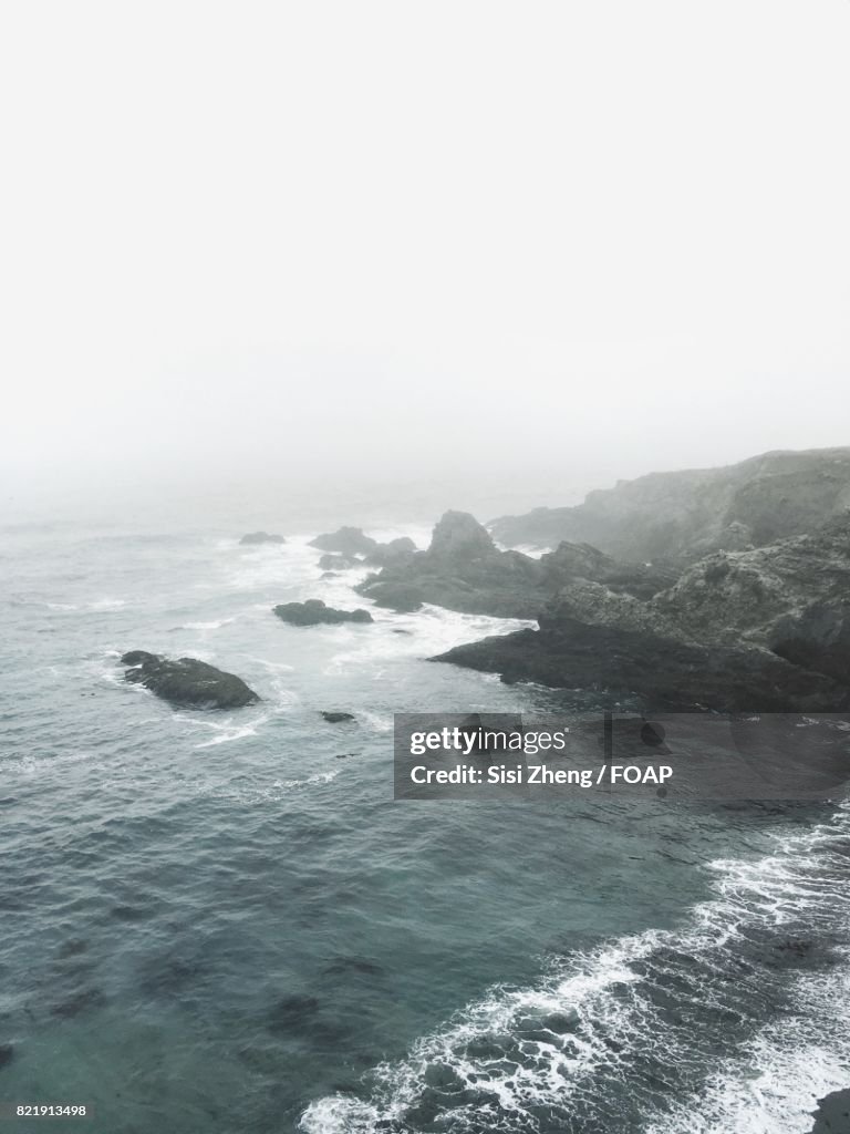 Scenic view of a beach on fog