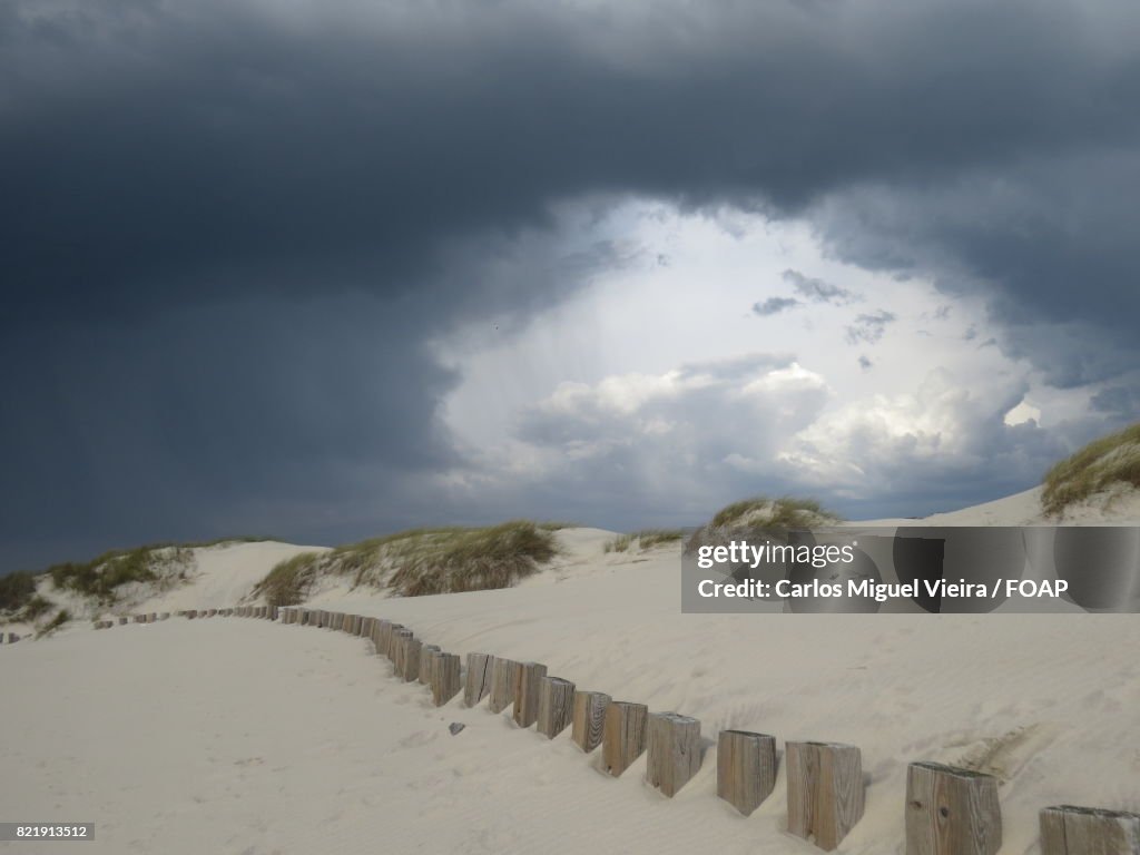 Storm cloud over sand