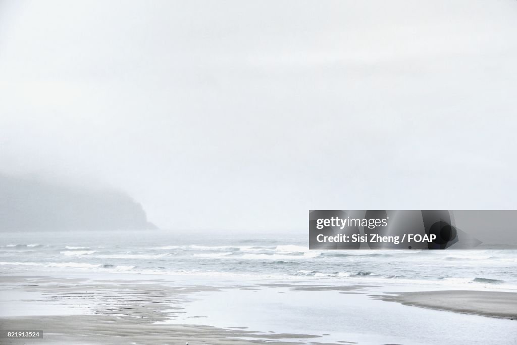 Scenic view of Cannon beach against clear sky