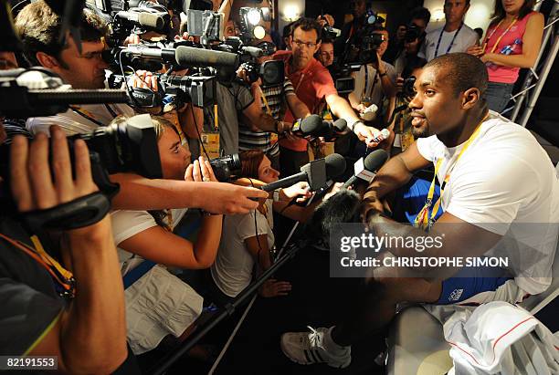 Judo athlete Teddy Riner from France answers journalists during a press conference at the "Club France" on August 6, 2008 in Beijing ahead of the...